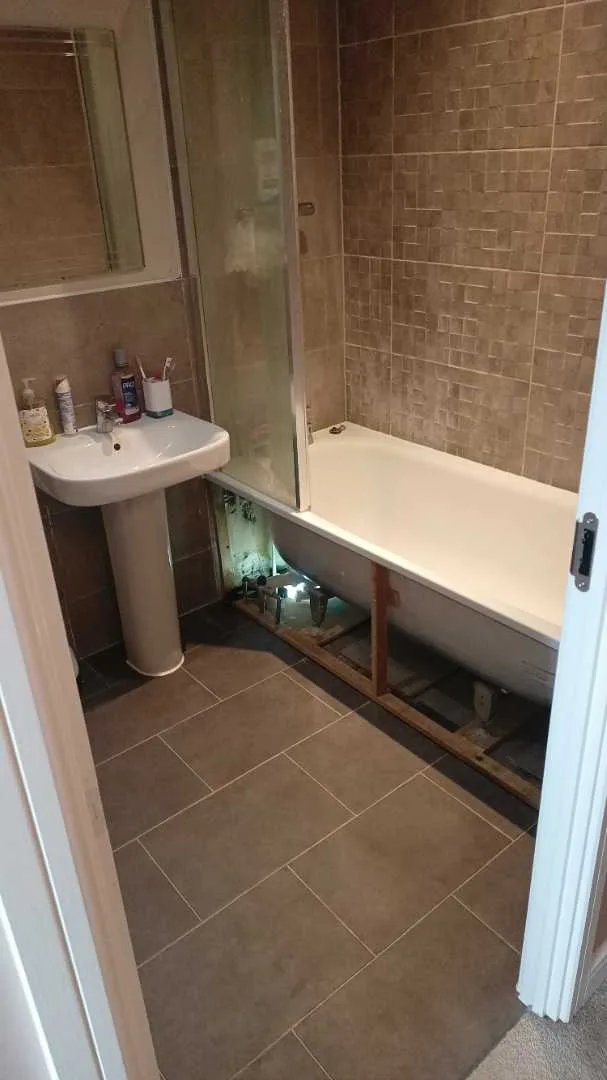 Bath panel removed to inspect concealed pipework in the rented home
